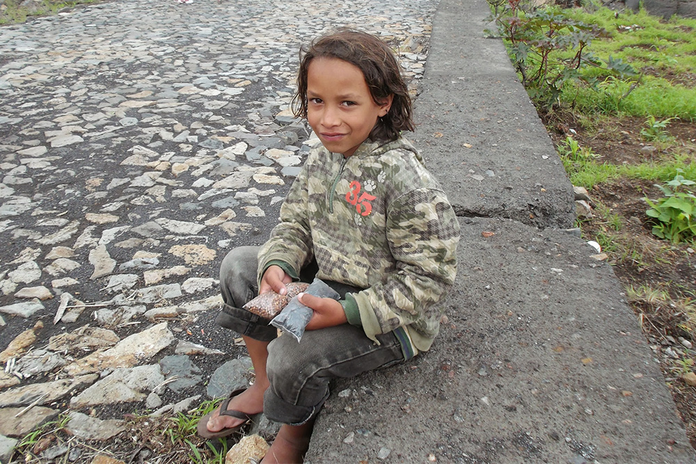A boy selling pepper picked from the trees growing on the Cha's fertile soil.