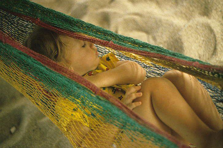 Baby sleeping in a hammock on Placlencia beach in Belize