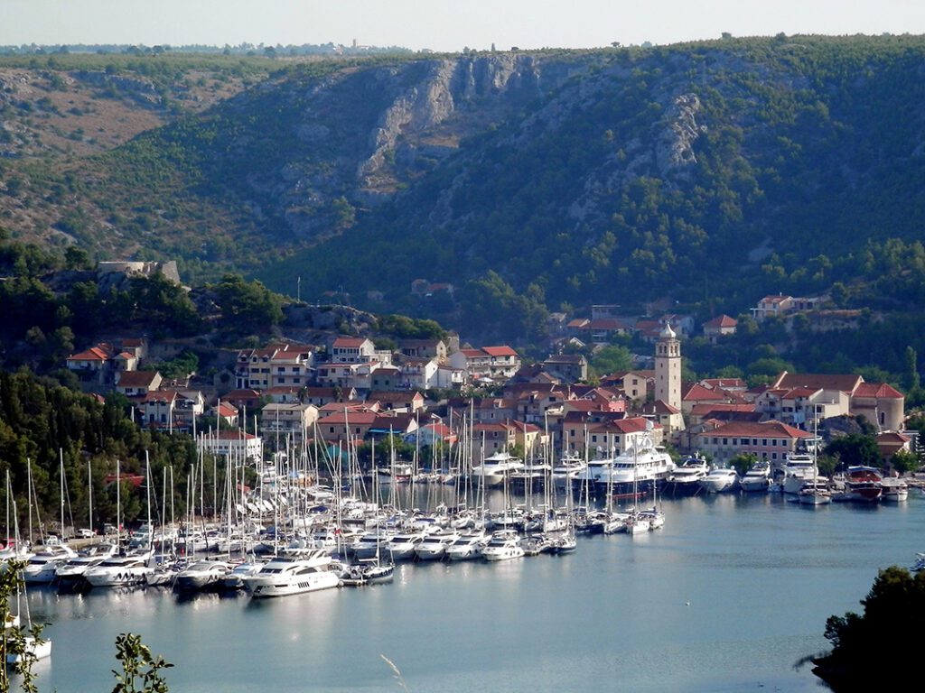 Skradin with the yacht harbor and the iconic tower clock of St. Spiridon.
