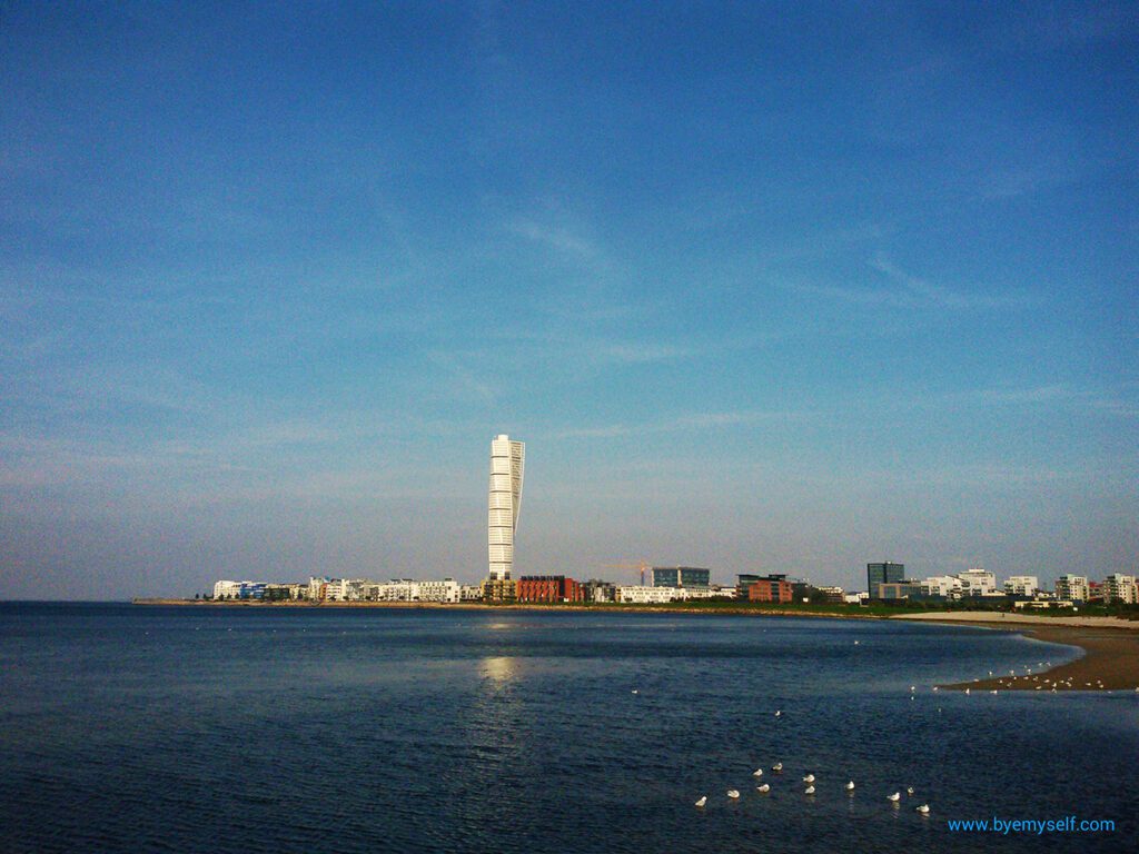 View of the Västra Hamnen, Malmö's "city of tomorrow" with the iconic "Turning Torso" from the city beach Ribersborgsstranden.
