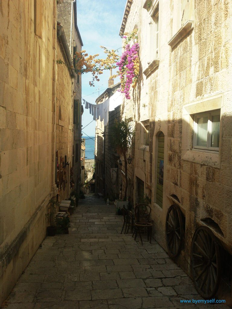 Narrow alley in Korcula leading to the shore.